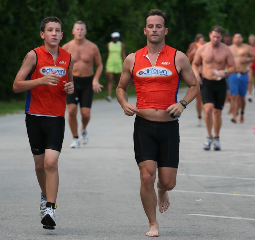 Matt Miller running beside a C Different athlete during an endurance race.